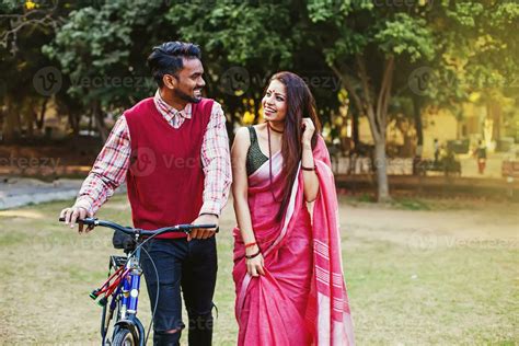 Young Indian couple in traditional ethnic clothes walking with the ...