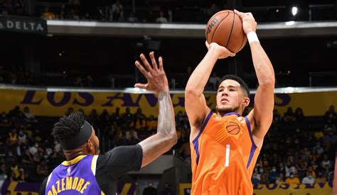 Devin Booker pump fakes and draws the foul as he drains the jumper ...