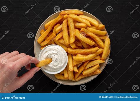 Hand Takes French Fries with Ranch Dressing, Top View Stock Photo ...