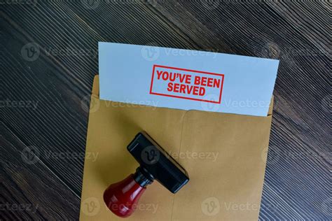 You've Been Served text on document above brown envelope. 23645712 ...