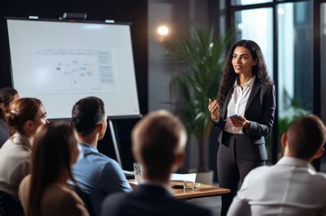 Woman lead trainer speaking with flip chart to colleagues at meeting ...