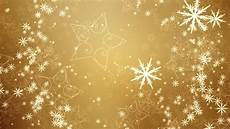 Gold Snowflake Background by Snowflakes And Slowly Fall Against A Gold Background Gold Snowflake Background