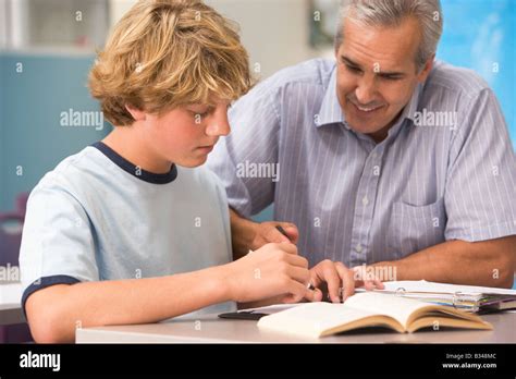 Teacher giving personal instruction to male student Stock Photo - Alamy