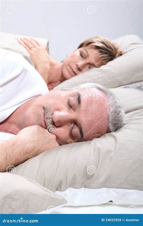 Couple in bed sleeping stock photo. Image of grey, home - 24022928