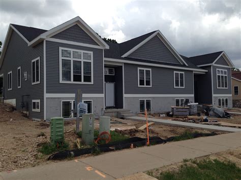 Dark gray vinyl siding with thick white trim | Vinyl house, Siding ...