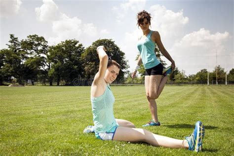 Two Young Girls Stetching before a Jogging Stock Image - Image of ...