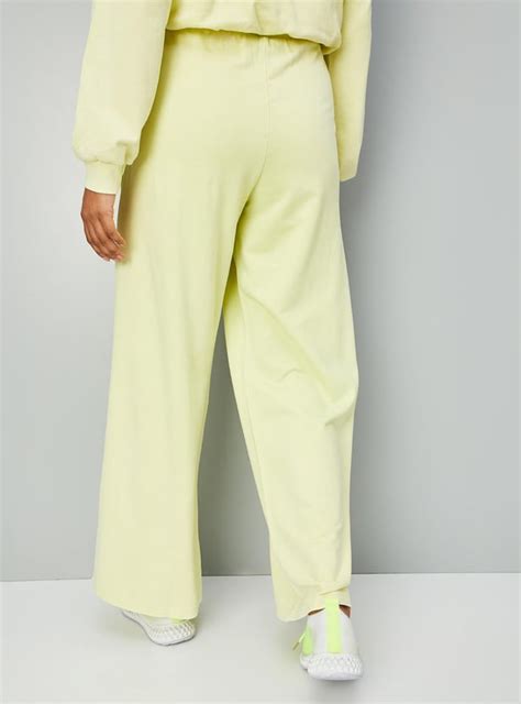 Buy Women Solid Wide Leg Track Pants Online at just Rs. 899.0 ...