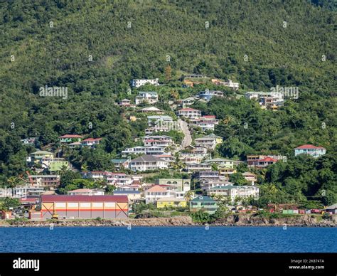 A view from the sea of the lush mountains surrounding the capital city of Roseau, on the west ...