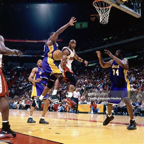 Tim Hardaway the Miami Heat drives to the basket and passes behind ...