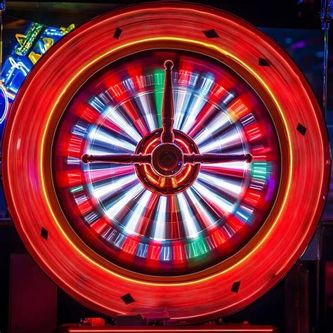 Close up of a spinning roulette wheel with red and yellow lighting ...