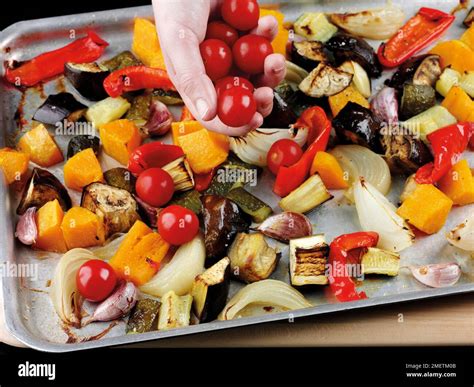 Adding cherry tomatoes to roasted vegetables (courgettes, aubergines ...