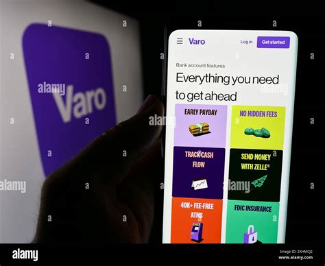 Person holding cellphone with webpage of US financial services company ...
