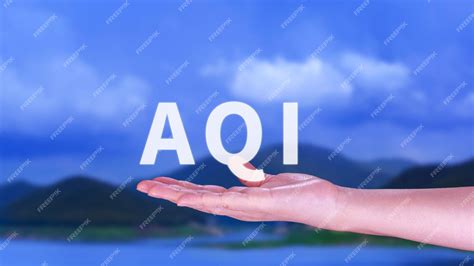 Premium Photo | AQI Abbreviation of air quality index hand holding AQI on nature background ...