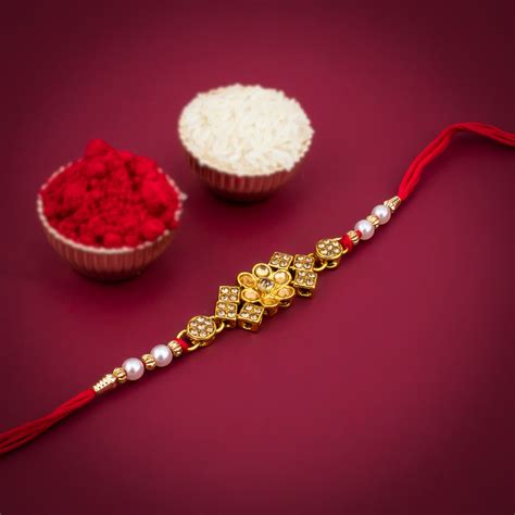 Sukkhi Blossomy Gold Plated Floral Rakhi with Roli Chawal and Raksha B ...