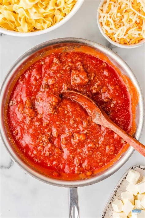 top-down view of a white 9x13 casserole dish of Grandmaâ��s ground beef casserole with a scoop out a