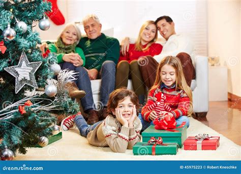Family with Gifts at Christmas Tree Stock Image - Image of gifts ...
