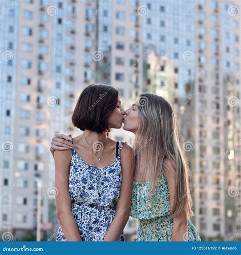 Lovely friendly girls kiss stock photo. Image of pair - 125516192