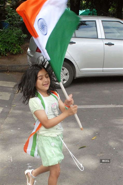 A small kid seen with Indian tricolour flag on Republic Day at Cubbon ...