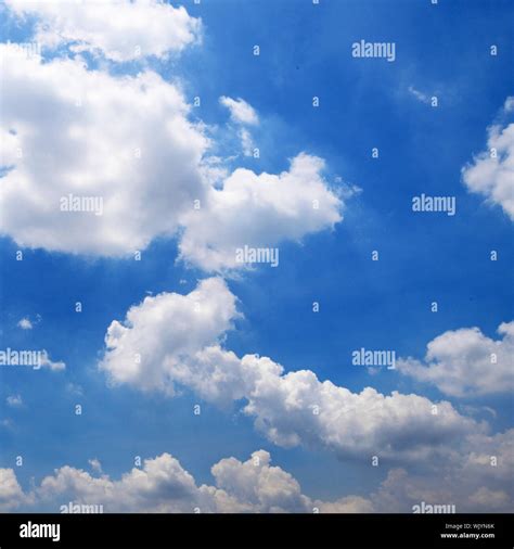 Blue sky with clouds background Stock Photo - Alamy