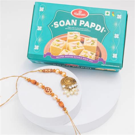 Send Divine Om & Golden Glow Rakhi Set Online