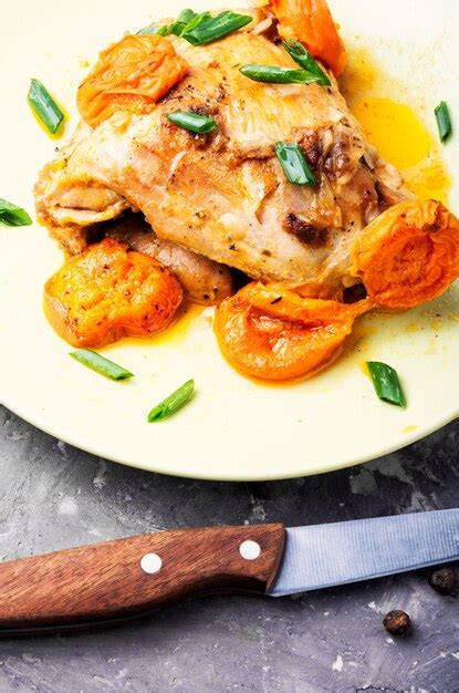 Chicken stewed in apricots | Premium Photo