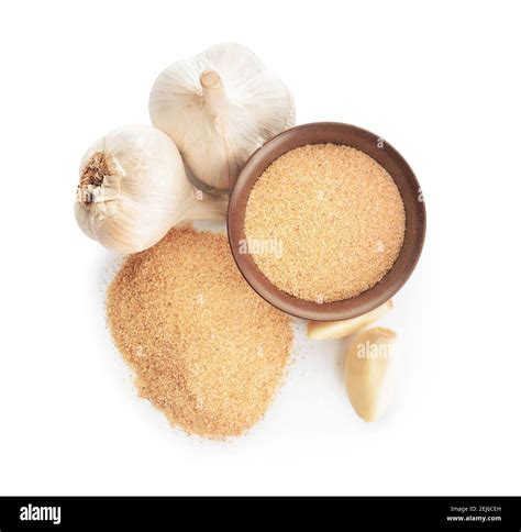 Bowl with aromatic powdered garlic on white background Stock Photo - Alamy