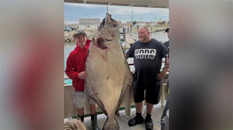 Teen fishing off New England coast catches huge halibut bigger than him