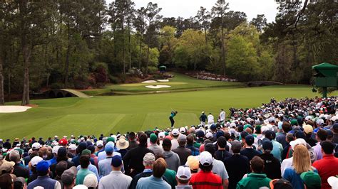 Masters champion Tiger Woods plays a stroke from the No. 12 tee during ...