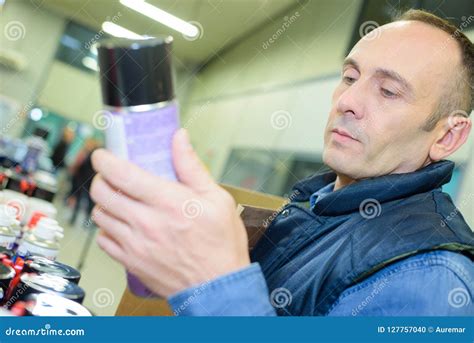 Cheerful Man Choosing Insects Killer Spray in Household Section Stock ...