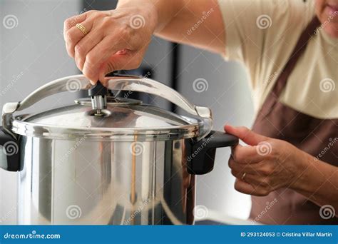 Mature Spanish Woman Placing Regulator Whistle on Pressure Cooker ...
