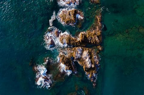Aerial shots of the turquoise water, reef formations, beach and shipwreck at Henrietta Rocks.
