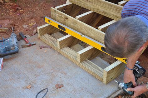 Learn how to anchor your deck stairs to a concrete landing pad or ...