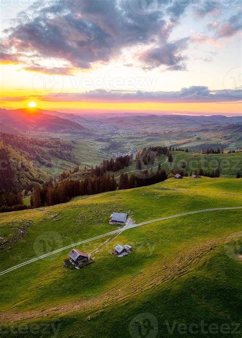 a farm high on the hills during a sunset in the distance you can see a hilly landscape 20863806 ...