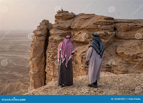 Two Arab Men in Traditional Clothing at the Edge of the World Near ...