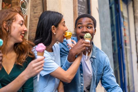 Premium Photo | Multiethnic friends in an ice cream parlor eating an ice cream summer fun girl ...