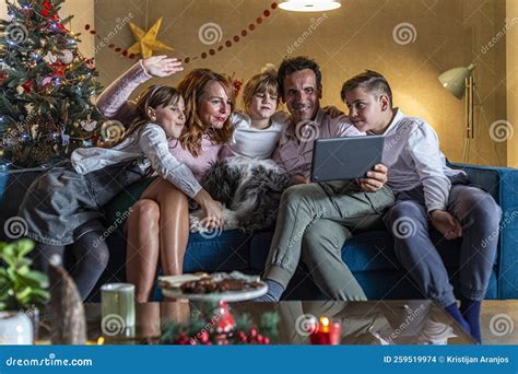 A Happy Family is Sitting on the Couch in Living Room and Having a ...