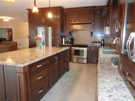 Stained cherry wood kitchen with light colored quartz countertop ...