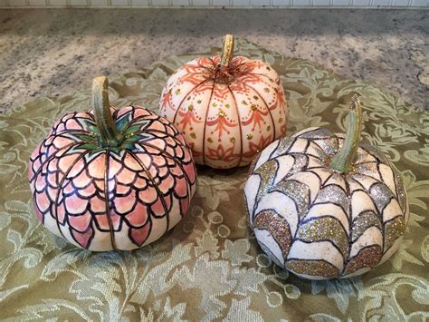Small white pumpkins decorated with glitter, acrylic paint, and a ...