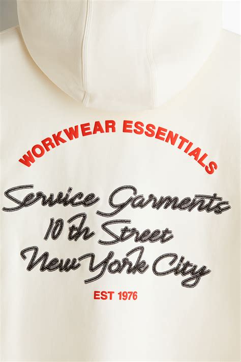 Loose Fit Motif-detail hoodie - White/Service Garments - Men | H&M IN