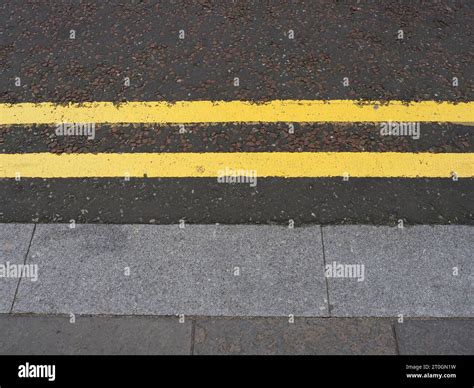 double yellow line no parking road marking sign Stock Photo - Alamy