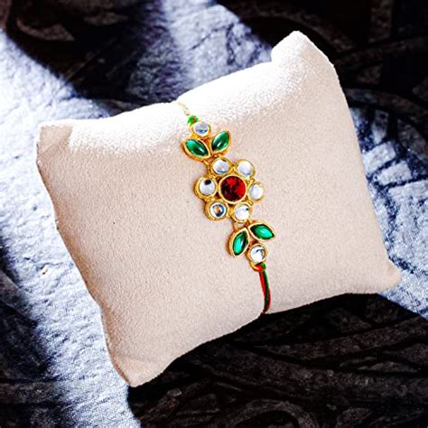 Buy Sukkhi Delightful Gold Plated Floral Rakhi with Roli Chawal and ...
