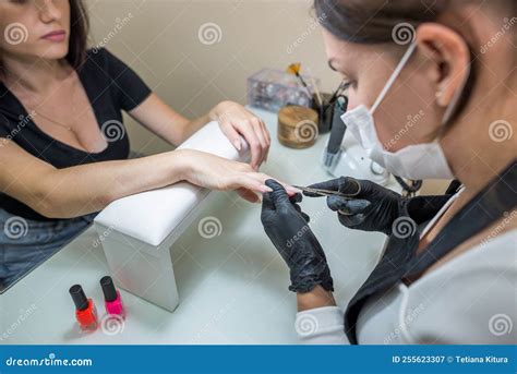 Manicure Salon Master Removes Cuticles with Nail Scissors. Woman ...