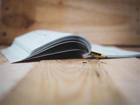 Close-up of pencil in open book on table | Premium Photo
