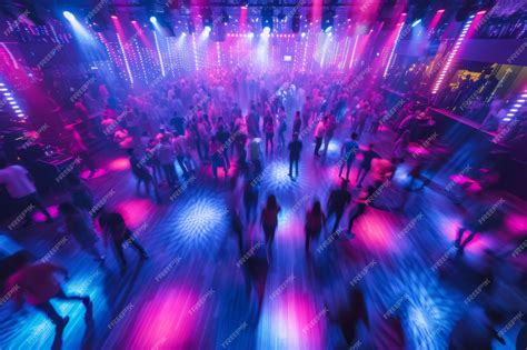 Packed nightclub dance floor with energetic dancers colorful lighting ...