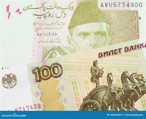 A Russian One Hundred Ruble Note Paired with a Pink and Grey Ten Rupee ...