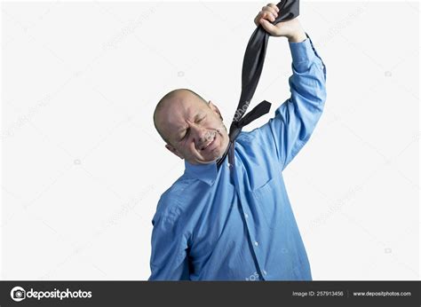 Man Choking Himself His Tie Stock Photo by ©YAYImages 257913456