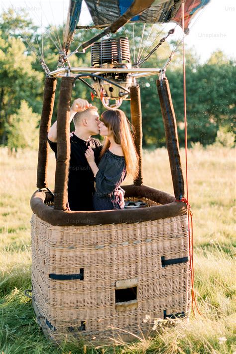 Beautiful romantic couple hugging in the basket of hot air balloon ...