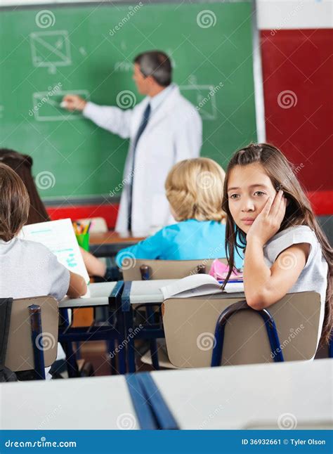 Bored Schoolgirl Sitting in Classroom Stock Image - Image of chin ...