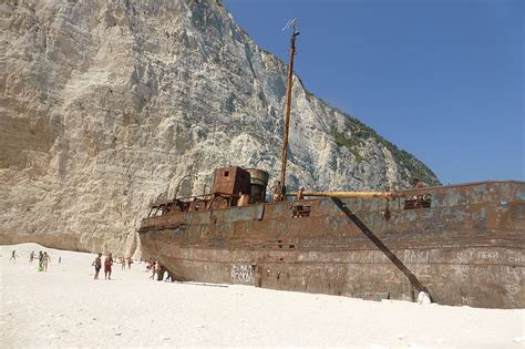 This rotting wreck resting on a white sandy beach is a major tourist ...