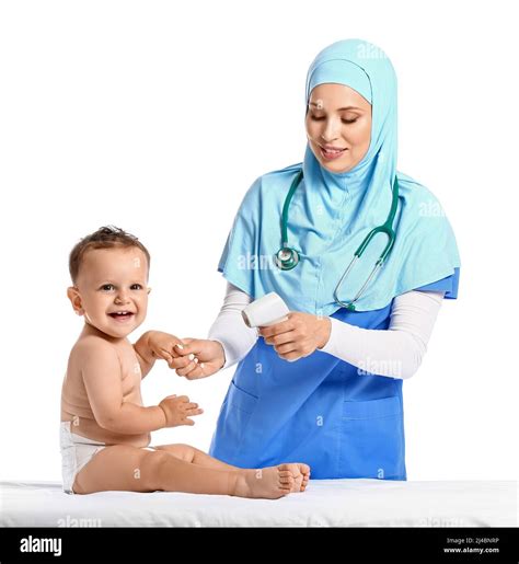 Muslim pediatrician measuring temperature of baby boy on white background Stock Photo - Alamy